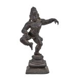 A small bronze dancing figure of Krishna, Southern India, 15-16th century, on double lotus base on