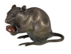 A large Chinese or Japanese bronze rat, seated holding a chestnut, marked to base