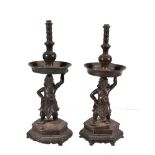 A pair of Chinese bronze figural taper or candlesticks, Ming Dynasty, 16 or 17th century, each