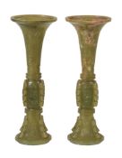 A pair of Chinese celadon and russet jade archaistic vases, gu, 19th or early 20th century, of