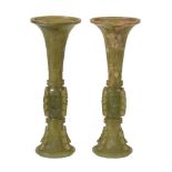 A pair of Chinese celadon and russet jade archaistic vases, gu, 19th or early 20th century, of