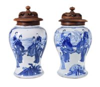 A pair of Chinese blue and white vases, Kangxi, painted with court scenes, originally once '