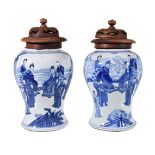 A pair of Chinese blue and white vases, Kangxi, painted with court scenes, originally once '