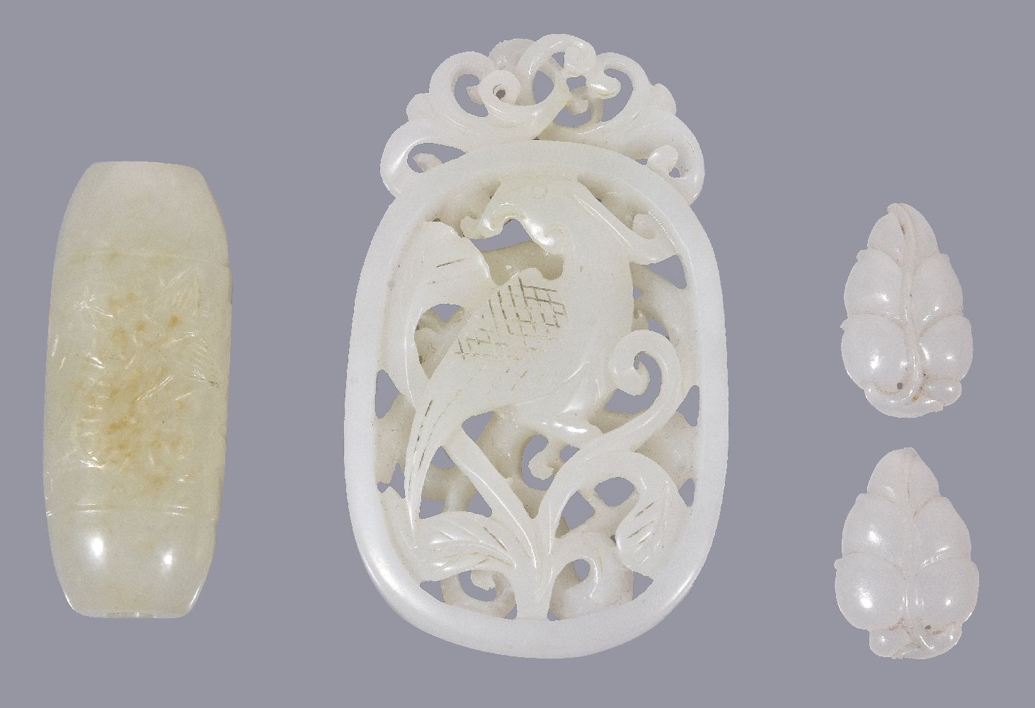 A Chinese white jade openwork pendant, carved with a bird amongst scrolling foliage, incised