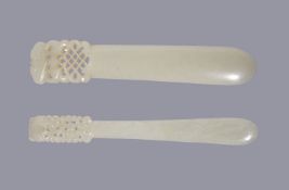 Two Chinese pale celadon jade hair pins, Qing Dynasty, 19th century, with openwork details one