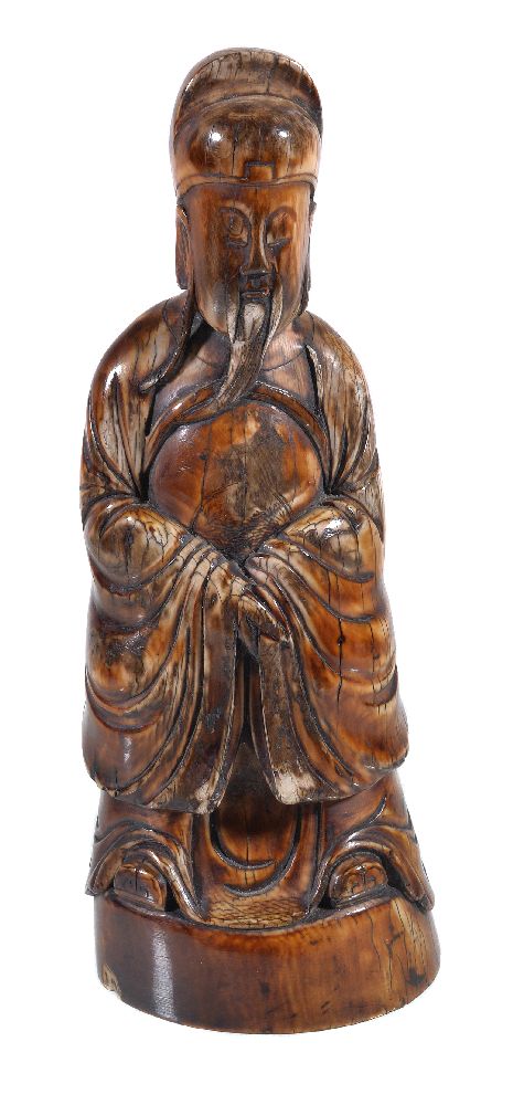 Y A Chinese ivory figure of an seated Official
