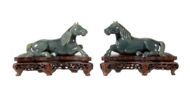 A pair of Chinese spinach jade models of recumbent horses, facing to the left and right, with carved
