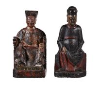 Two Chinese lacquered wood figures of Court Officials, probably 17th-18th century, both seated and
