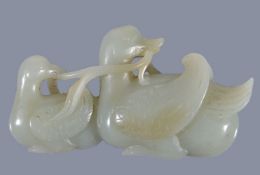 A Chinese celadon jade carving of two Mandarin ducks, Qing Dynasty, 19th century, the feathers