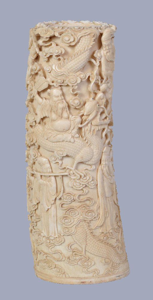 Y A Chinese Ivory tusk vase, of typically curved form deeply carved in relief with dragons Guan Yin