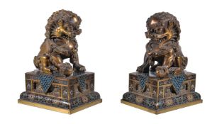 A pair of Chinese gilt-bronze Buddhist lions, with cloisonné bases, overall height 20cm and the