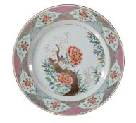 A large pair of Chinese Famille Rose plates, Qianlong, each painted to the centre with a flowering