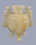 A Chinese pale celadon jade bowl and cover, with some brown inclusions, supported on three lion