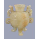 A Chinese pale celadon jade bowl and cover, with some brown inclusions, supported on three lion