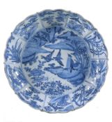 A Chinese blue and white dish, 17th century, the centre painted with two herons perched on rocks and