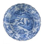 A Chinese blue and white dish, 17th century, the centre painted with two herons perched on rocks and