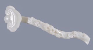 A white jade 'Lingzhi' ruyi sceptre, terminating in a large lingzhi head, the curved shaft worked in
