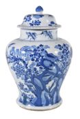 A Chinese blue and white vase and a cover, Kangxi, of inverted baluster shape, painted with