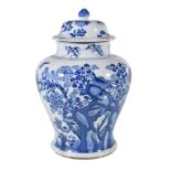 A Chinese blue and white vase and a cover, Kangxi, of inverted baluster shape, painted with