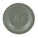 A Chinese Longquan celadon 'Twin Fish' dish, Southern Song Dynasty, the interior moulded with a pair