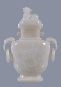 A Chinese white hardstone vase and cover, probably circa 1900-1930, the flattened ovoid body carve