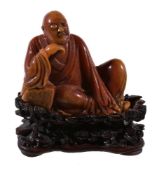 A small Chinese Shoushan soapstone carving of a Luohan, Qing Dynasty, 18th or 19th century, seated
