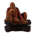 A small Chinese Shoushan soapstone carving of a Luohan, Qing Dynasty, 18th or 19th century, seated