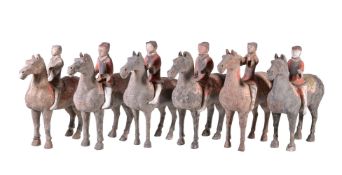 Six Chinese painted grey pottery Equestrian groups, Han Dynasty, standing four square with heads