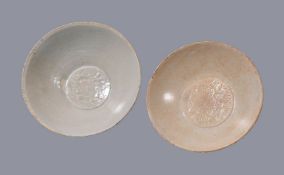 Two Qingbai glazed bowls, Southern Song-Yuan Dynasty, each moulded to the centres with twin fish,