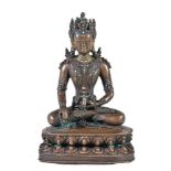 Y A Tibetan bronze figure of Buddha, seated in padmasana on a double lotus throne holding a fruit