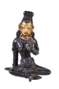 A small Tibetan bronze figure of Tara, seated with legs loosely crossed, her left hand in varada