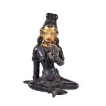 A small Tibetan bronze figure of Tara, seated with legs loosely crossed, her left hand in varada