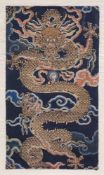 A Chinese brocade fragment of a large coiling five clawed dragon, Qing Dynasty, Kangxi period, early