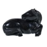 A Chinese carved stone or jade model of a horse, the reclining animal well carved with its head