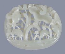 A Chinese white or pale celadon oval 'crane and lotus' plaque, worked with a tubular border