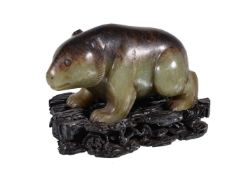 A Chinese celadon and brown jade bear, with incised details, the natural brown marking to the stones