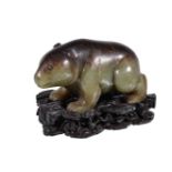 A Chinese celadon and brown jade bear, with incised details, the natural brown marking to the stones