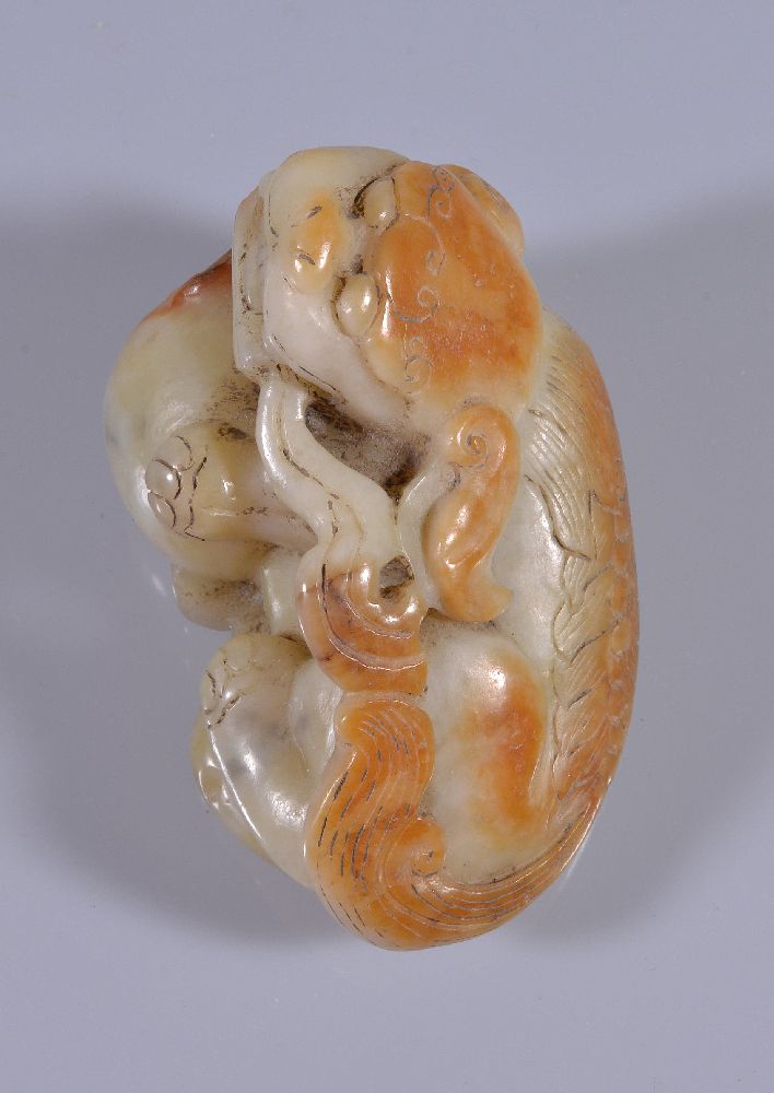 A Chinese white and russet jade Buddhist lion, with incised details, the mouth slightly opened - Image 3 of 4