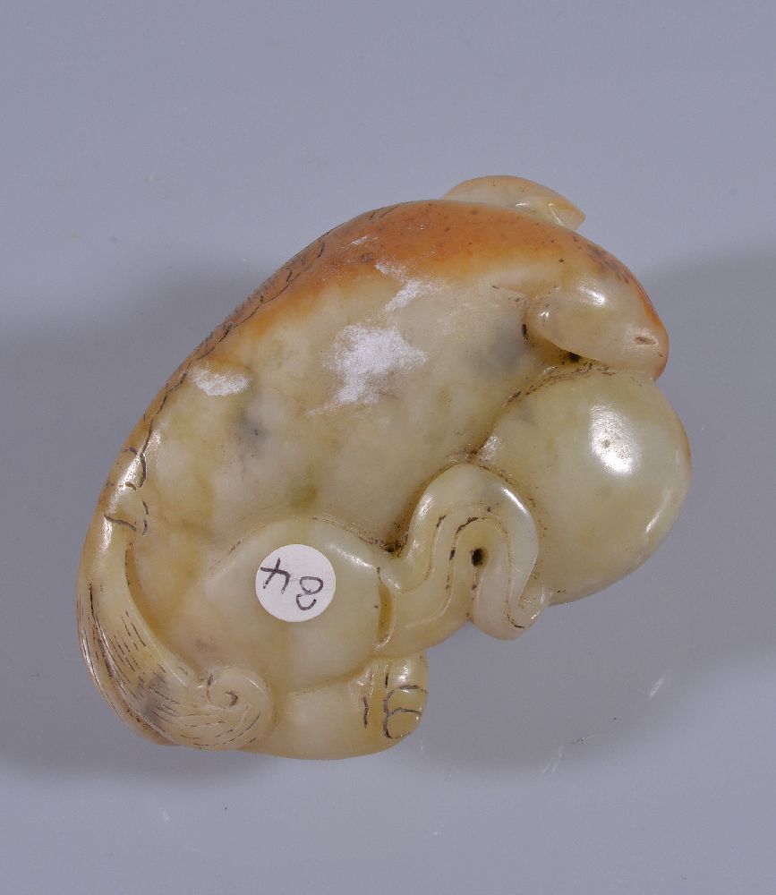 A Chinese white and russet jade Buddhist lion, with incised details, the mouth slightly opened - Image 4 of 4