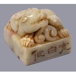 A Chinese 'Mythical Beast' square jade or hardstone seal, possibly 18th or 19th century, the pale