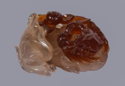 A Chinese agate 'crab and lotus' carving, the smoky-grey chalcedony section of the stone carved as a