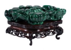 A Chinese malachite brush washer, Qing Dynasty, 19th century, carved and flowers and stems, the base