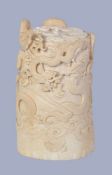 Y A Japanese Ivory tusk vase, the thin body carved in high relief with convoluted dragons