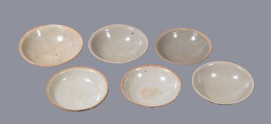 Six Chinese shallow bowls, Southern Song-Yuan Dynasty, with various celadon and grey glazes, the