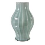 A fine Chinese celadon-glazed vase, Qing Dynasty, Qianlong mark and period, the baluster body