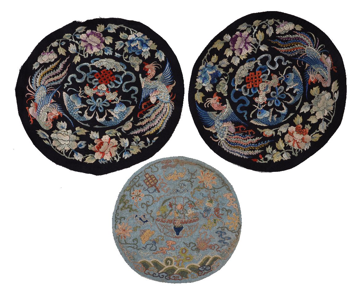 Three Chinese embroidered roundels, Qing Dynasty, one small blue example, 18th century,