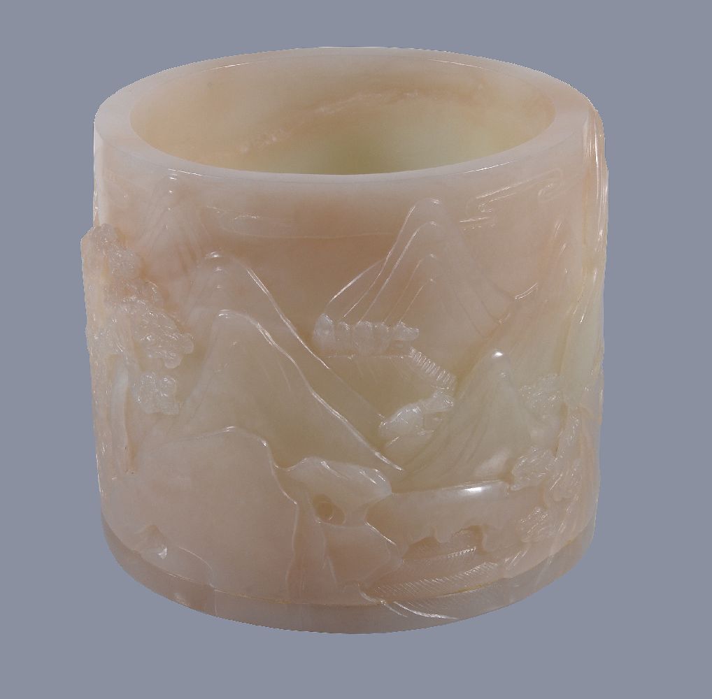 A Chinese white jade brush pot, carved with mountainous landscapes with horses and pine trees, the