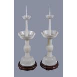 A pair of Chinese white jade candlesticks, each well carved in the form of a tapering cylinder