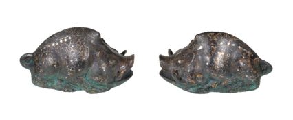 A pair of Chinese archaistic silver inlaid bronze boars, with legs facing forward and showing the