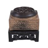 A Chinese archaistic brown and black jade cong, well carved with 'C' scrolls to each side, 5cm x